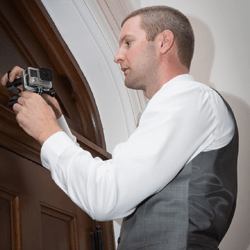 A photograph of videographer, Matthew Churpita, setting up a video camera.